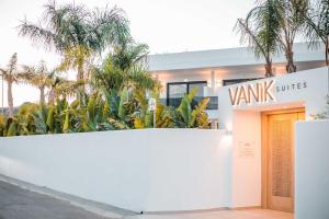 a white building with a sign that reads vault suites at Vanik Suites in Kallithea Rhodes