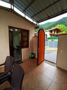 an open door to a patio with a table and chairs at Guest house DAVID in Borjomi