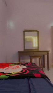a bedroom with a bed with a table and a window at Hostel 35 in Medina