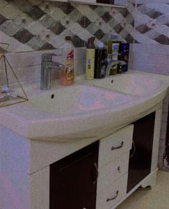 a white bathroom sink with pink dye on it at Hostel 35 in Al Madinah