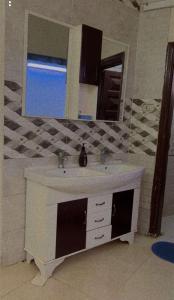 a bathroom with a sink and a mirror at Hostel 35 in Al Madinah