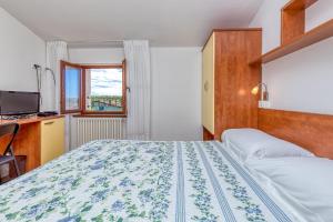 a bedroom with a large bed and a window at La Quiete B&B in Lovrečica +23 photos