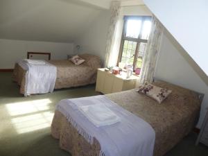 מיטה או מיטות בחדר ב-Strawberry Cottage B&B