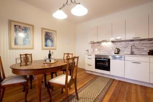 a kitchen with a wooden table and a dining room at Reiterhof Behrens Wohnung Sachau in Merkendorf