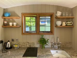 a kitchen with a sink and a window at Shepherds Rest Bruton in Bruton