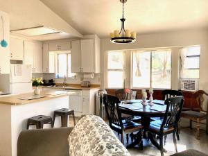 a kitchen and dining room with a table and chairs at NEW! Cozy & Secluded House w/Deck - Near Yosemite! in Tuolumne