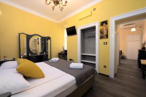 a bedroom with a large bed and a mirror at Apartment Korzo Filodrammatica in Rijeka