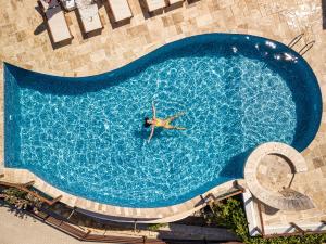 an overhead view of a person swimming in a swimming pool at Les Terrasses De Selimiye in Selimiye +36 photos