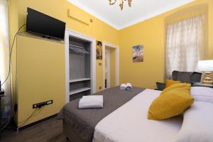 a bedroom with a bed with a flat screen tv on it at Apartment Korzo Filodrammatica in Rijeka