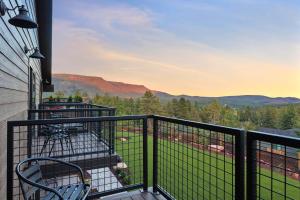 a balcony with chairs and a view of the mountains at Lodge at 5600 in Pine