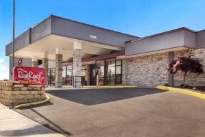 a building with a coca cola sign in front of it at Red Roof Inn PLUS & Suites Erie in Erie