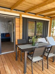 a patio with a table and chairs on a deck at Rosmarin&Olive Premium Mobile Homes in Selce