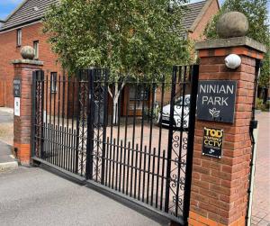 a black iron fence with aiman park sign on it at Holiday Home In Cardiff, Sleeps 8 in Cardiff