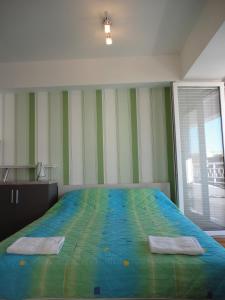 a bedroom with a bed with two towels on it at Accommodation Mell in Ohrid
