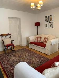 a living room with a couch and a chair at Butler's Cottage, Letterkenny in Letterkenny
