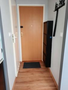 a hallway with a door and a rug at Jelitkowo Beach Apartment in Gdańsk +3 photos