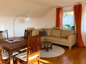 a living room with a couch and a table at Ferienwohnung Marienhöhe in Nördlingen