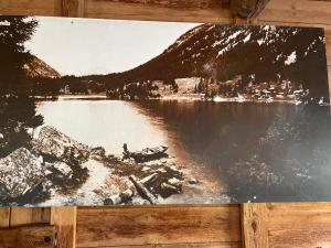 une photo en noir et blanc d'un lac avec une ville dans l'établissement Au Vieux Champex, à Champex-Lac