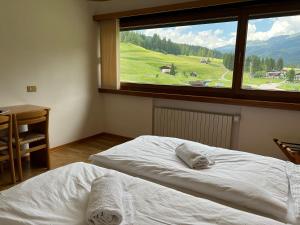 Postel nebo postele na pokoji v ubytování Hotel D'La Varda