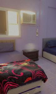 a bedroom with a bed with a blanket on it at Hostel 35 in Medina