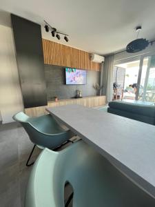 a kitchen with a large table and a blue chair at Black Pearl in Novalja