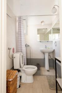 a bathroom with a toilet and a sink at MK Apartment in Lávrion