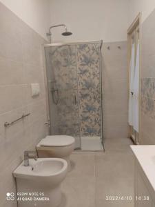a bathroom with a shower and a toilet and a sink at Villa Lucetta in Otranto
