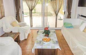a living room with a bowl of fruit on a table at Gorgeous Home In Riba-roja De Tria With Outdoor Swimming Pool in Riba-Roja De Turia