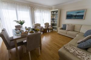 a living room with a table and a couch at Home Sweet Home by ACasaDasCasas in Ericeira
