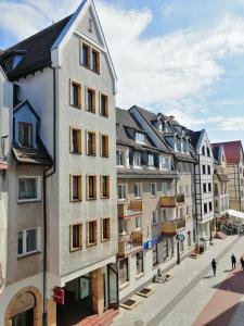 a row of buildings on a city street at Cicha Przystań Apartament Starówka in Kołobrzeg