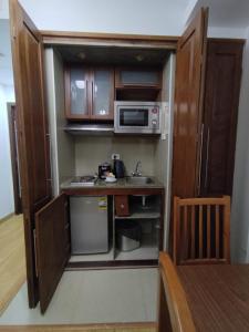 a small kitchen with a sink and a microwave at E-Just Hotel Borg El Arab in Borg El Arab