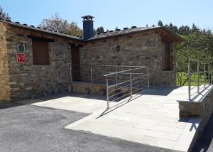a stone building with a staircase in front of it at Vivienda Turistica in Coto