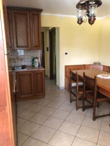 a kitchen with a table and chairs and a table and a dining room at Casa vacanze pila in Charvensod