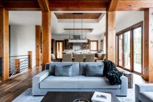 a living room with a couch and a dining room at Mountain Valley Estate in Big Sky