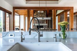 a kitchen with a sink and a vase of flowers at Mountain Valley Estate in Big Sky