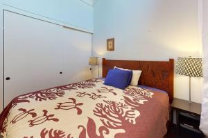 1 dormitorio con 1 cama grande y escritorio con 2 lámparas en Magnificent Sunsets and Ocean views at Luana Kai, en Kihei
