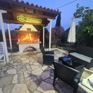 a patio with a fire pit and an umbrella at Marmara villa in Egira