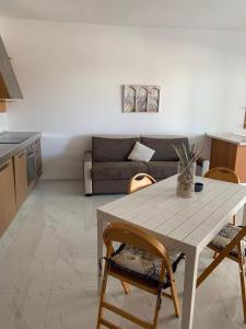 a living room with a table and a couch at Nautilus Room&Apartment in Polignano a Mare
