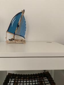 a model of a boat sitting on a white table at Nautilus Room&Apartment in Polignano a Mare