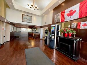 a large room with a lobby with canadian flags at Travelodge by Wyndham Winnipeg in Winnipeg