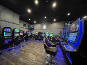 a room filled with lots of video game machines at Travelodge by Wyndham Winnipeg in Winnipeg