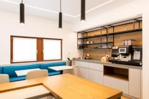 a kitchen with a blue couch and a table at Casa Fullin in Belluno
