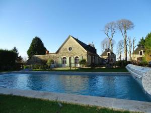 une maison avec une piscine en face d'une maison dans l'établissement Le Clos des Aubrys, à Châteauroux