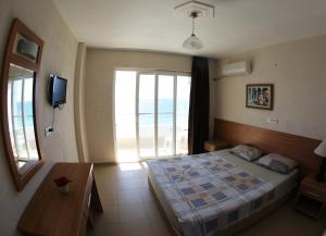a bedroom with a bed and a view of the ocean at Mavi Cennet Camping Caravan in Kızılot +72 photos