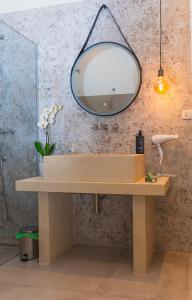 a bathroom with a wooden vanity with a mirror at Villa Padula in Sogliano Cavour