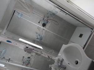 a bathroom with a sink and a mirror at Lilly house in Catania +16 photos