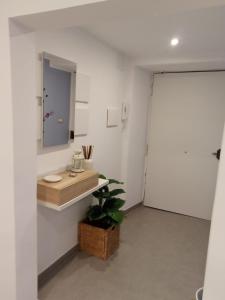 a bathroom with a sink and a mirror on a wall at Lilly house in Catania