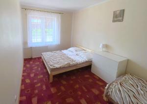 a small bedroom with a bed and a window at Jaśmin in Budry