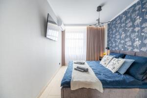 En eller flere senge i et værelse på Apartament 55m2 - Darmowy Garaż - Klimatyzacja - Centrum - 24na7