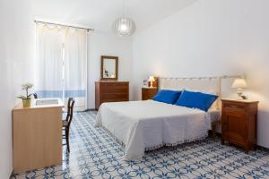 a bedroom with a bed and a table and a mirror at Il Canestro Sardo in Cagliari